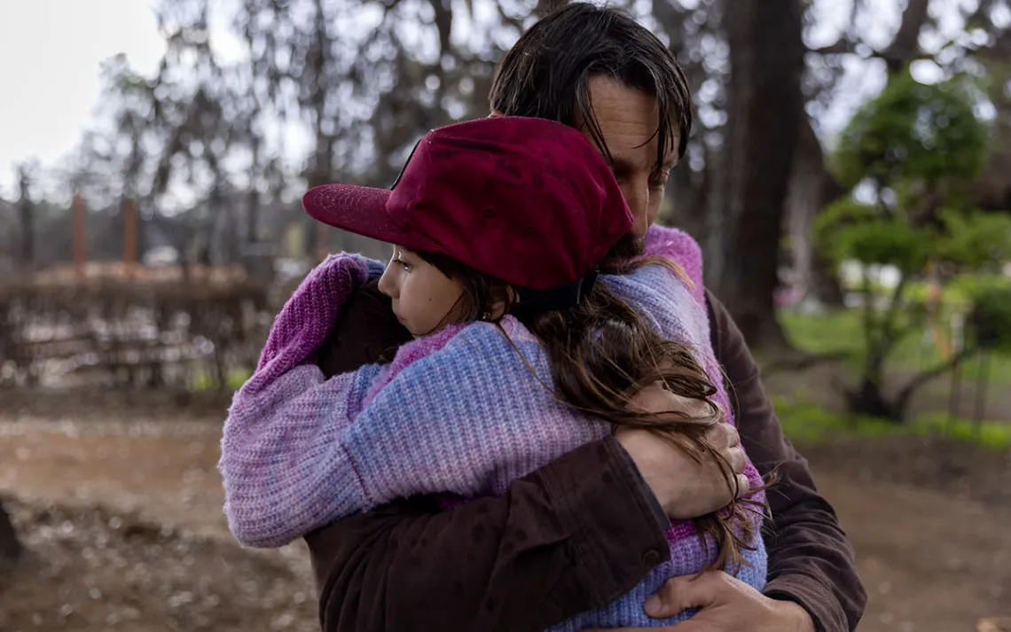 A daughter and her dad hug 