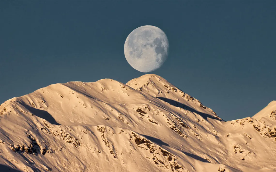 Low angle view of moon over the mountains   