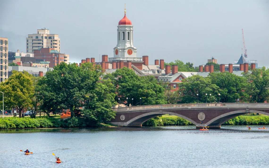 Kayaking under the John W. Weeks Bridge in the Charles River with Harvard University campus in Cambridge, Massachusetts, in the background. 