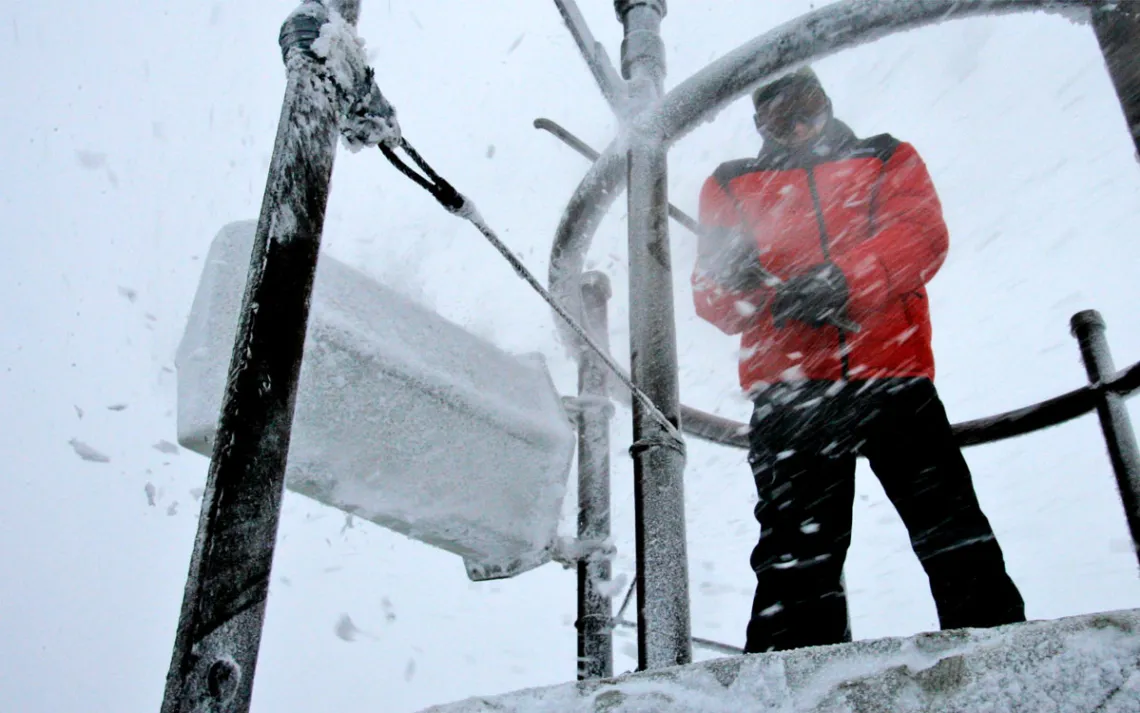 A weather observer knocked ice and snow off of a device atop Mount Washington