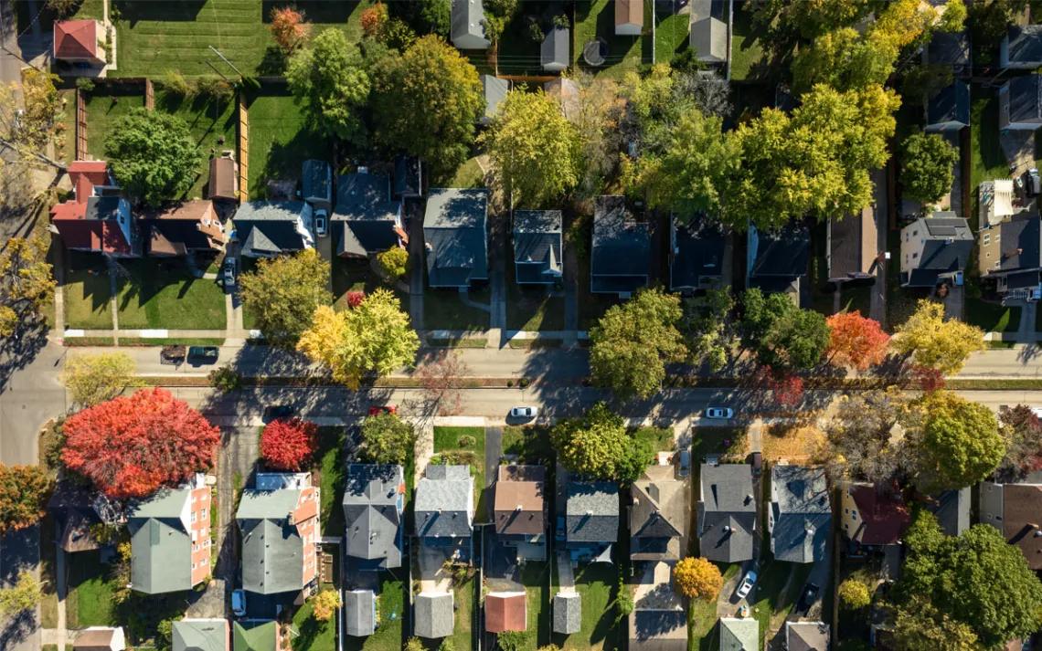 An aerial view of a lush community flushed with autumnal colors.