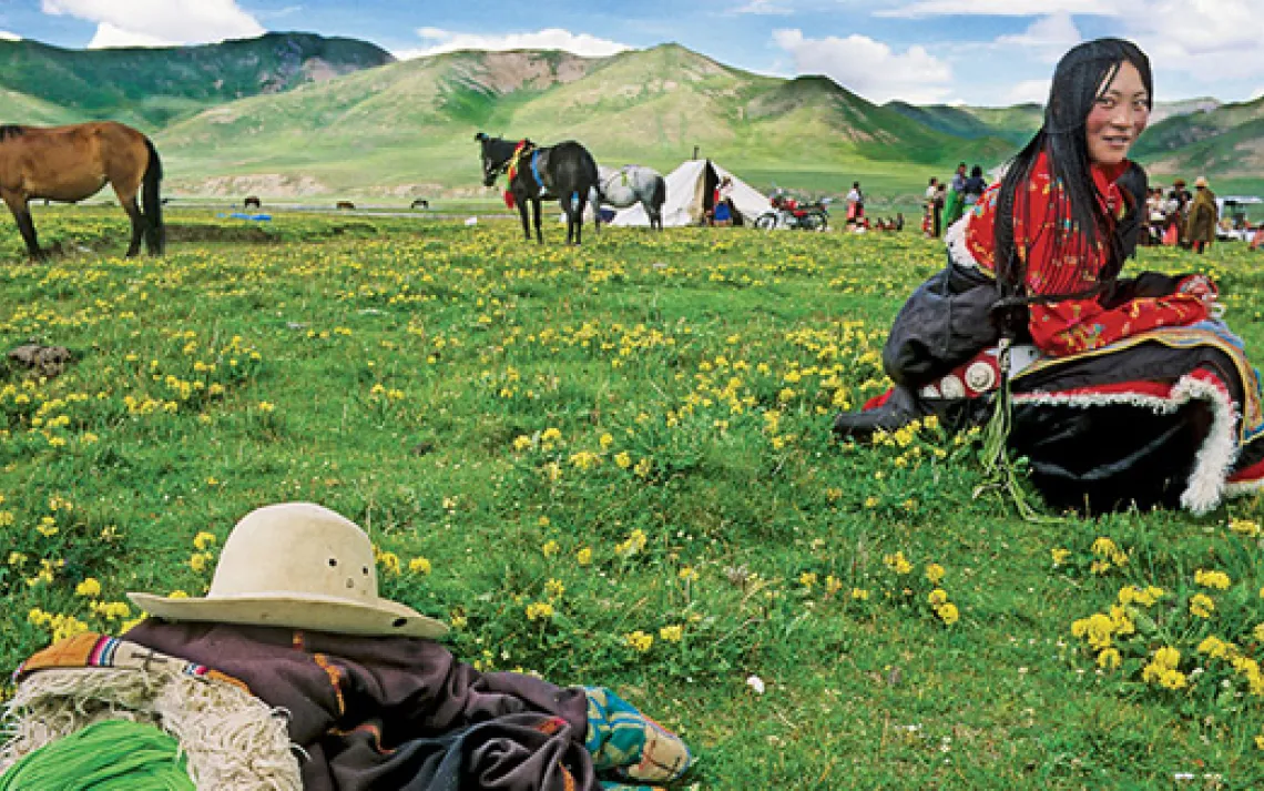 Near the headwaters of the Yellow River in China's Qinghai Province, a Golok nomad relishes the Tibetan Plateau's short-lived summer.