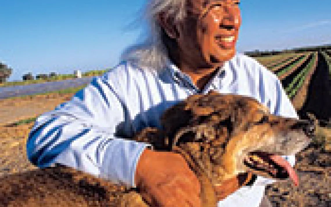 Harvard grad Hugo Morales, with his dog, Revolution, spent his childhood picking fruit on a farm. Now he works to keep pesticides from poisoning laborers, regardless of where they are from.