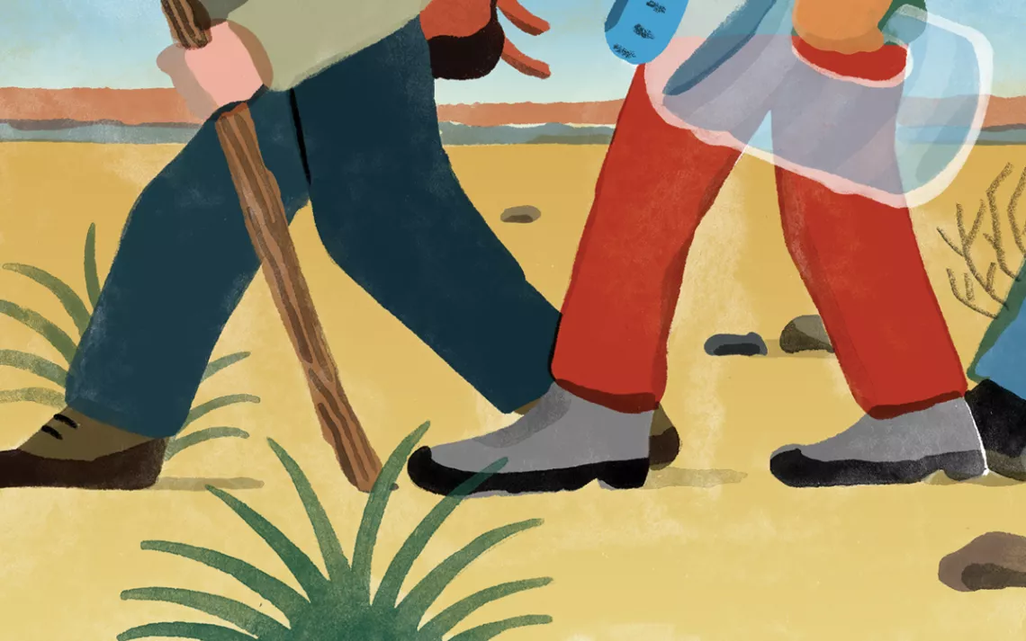 Three hikers in a desert. 