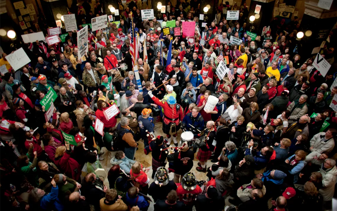Union firefighters and Wisconsin residents protest in the Madison state capitol.