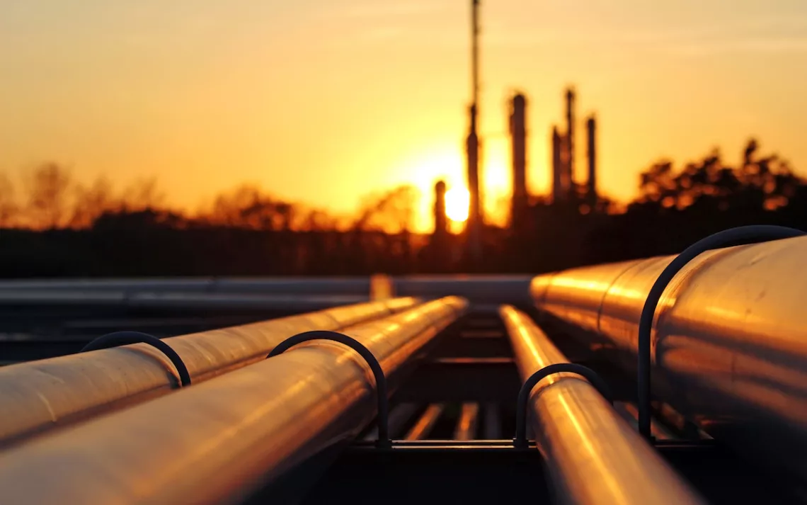 Crude oil refinery during sunset with pipeline connection