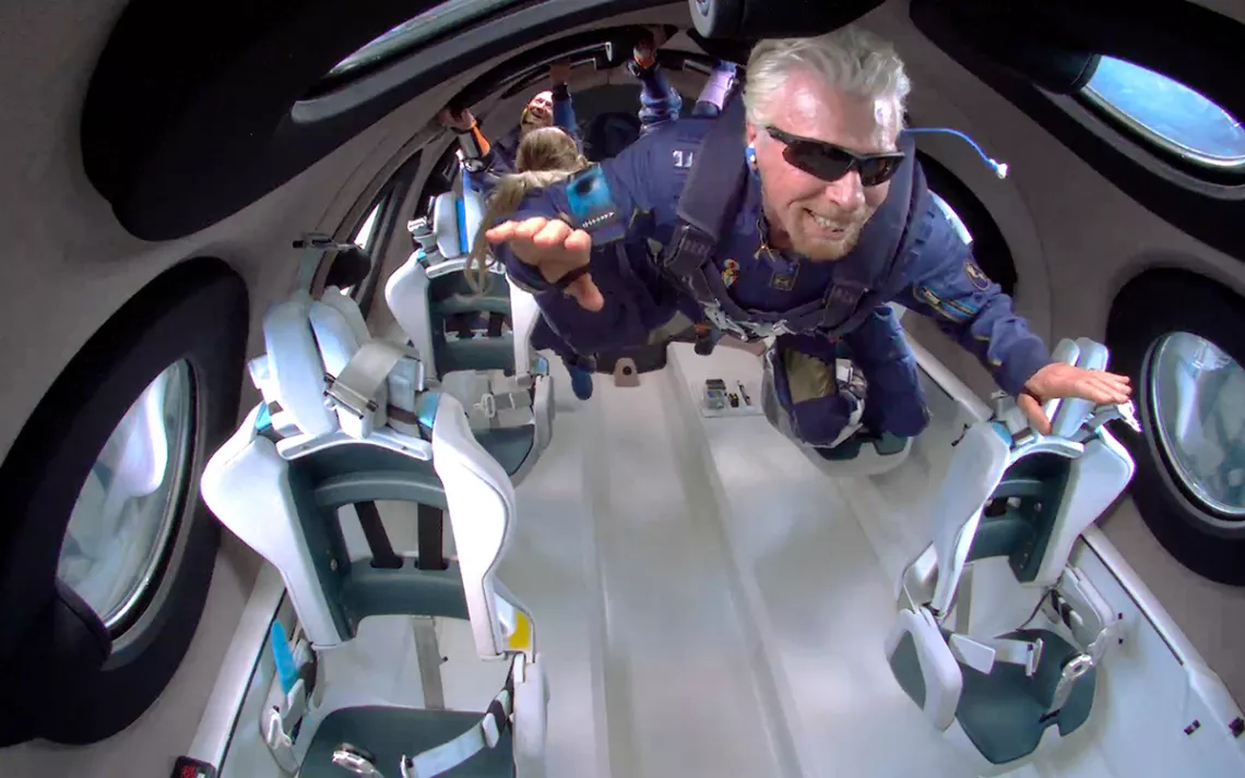 Billionaire Richard Branson floats inside a fancy rocket.