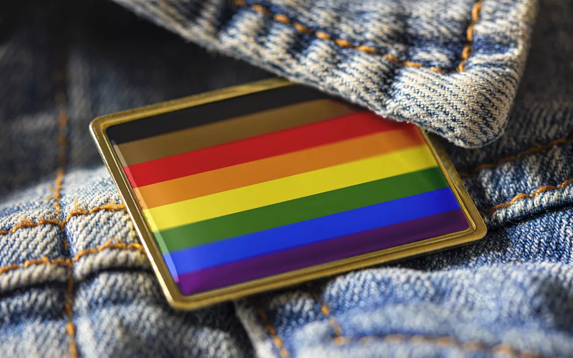 Rainbow flag pin on a denim backdrop