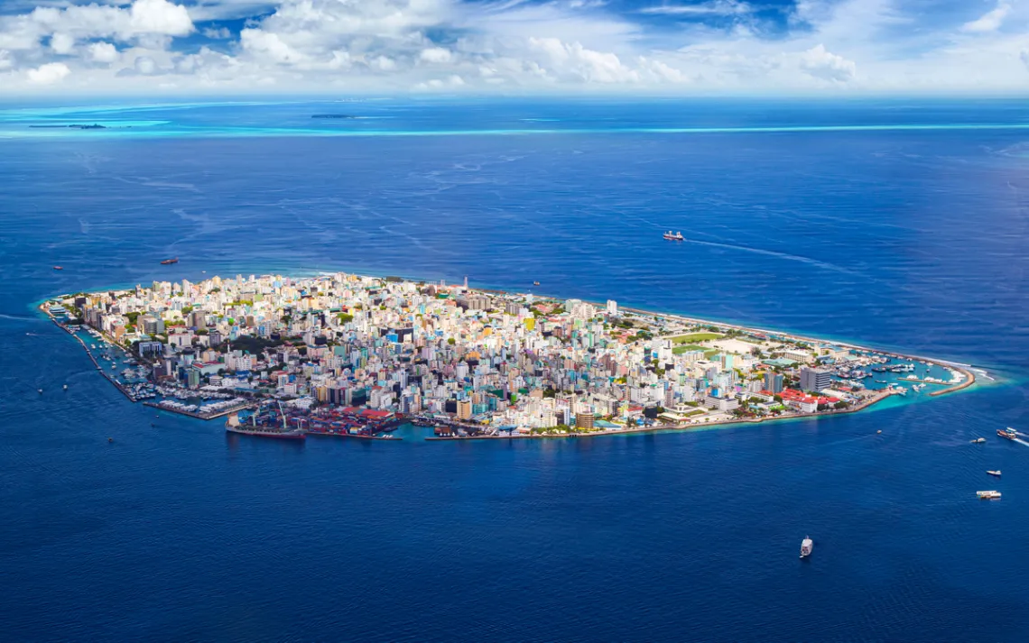 Crowded metropolis jammed onto an island in the middle of the blue ocean