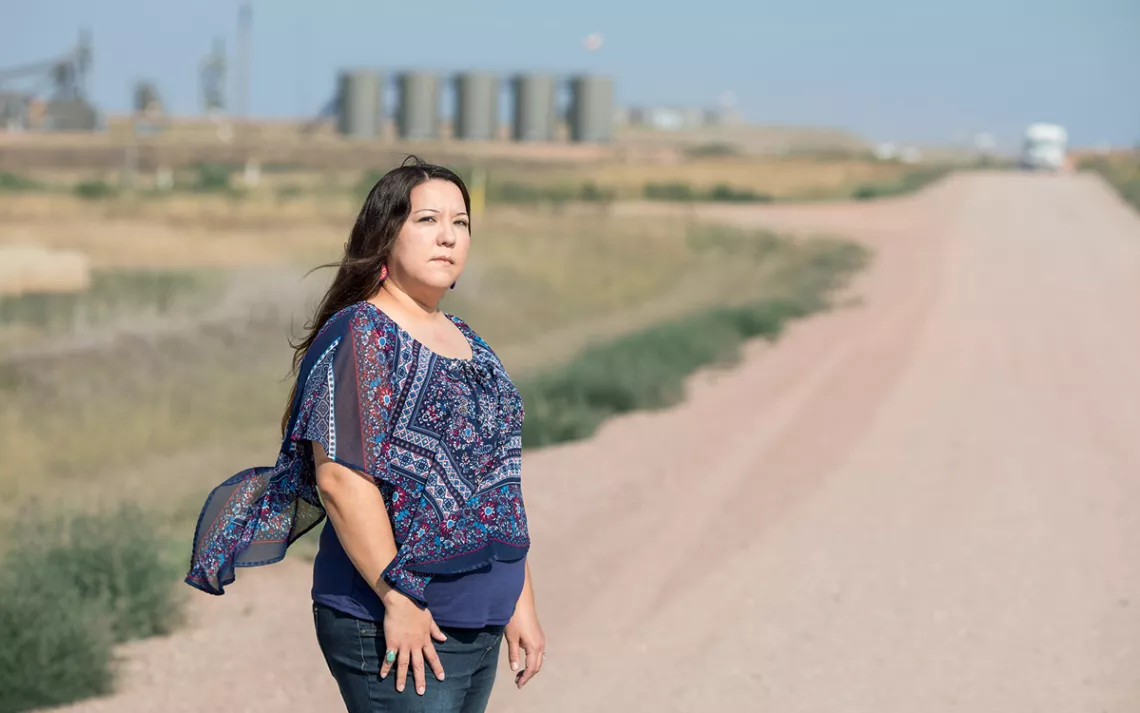 Kandi Mossett stands near the center of North Dakota’s oil fields.
