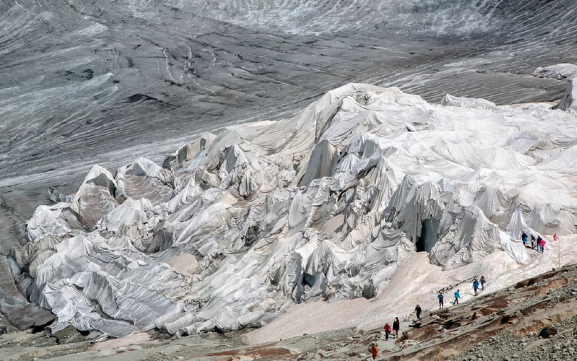 The Rhone Glacier in Switzerland is shrinking, but every year nearby residents cover up a portion of the ice with heavy-duty fleece to slow the melting.