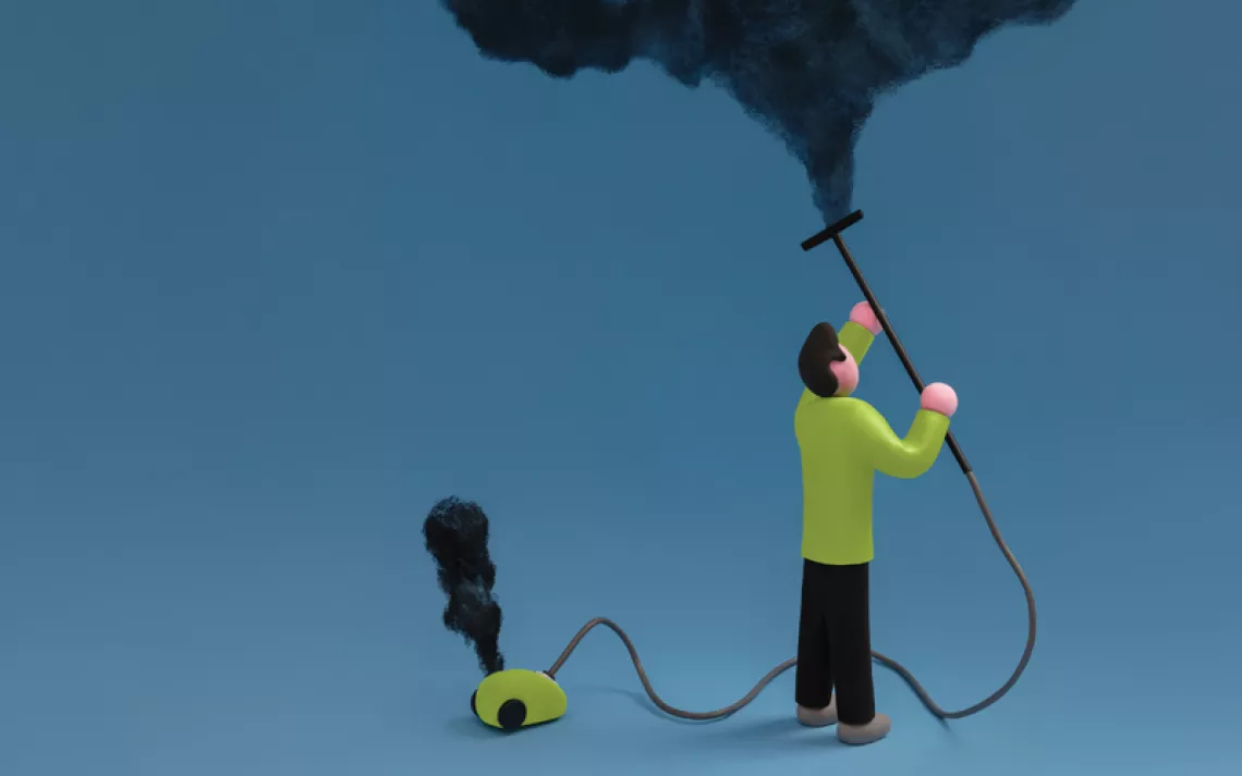 Illustration shows a man with a small green vacuum, sucking black smoke out of the air against a blue background.