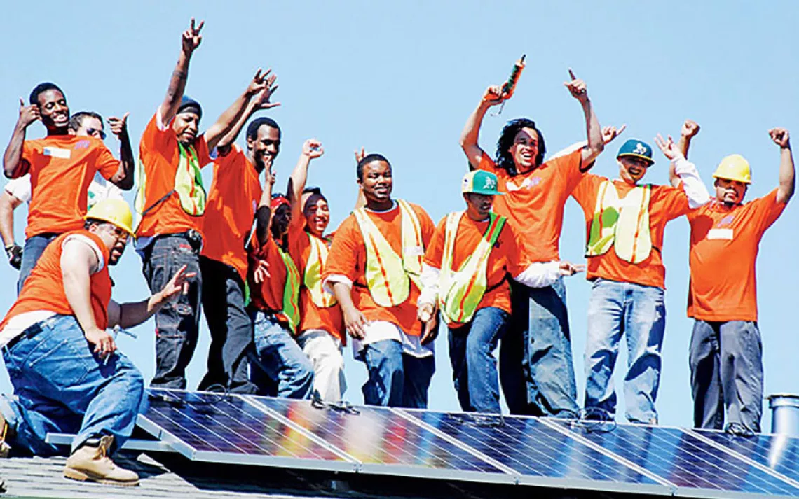 Graduating trainees at Solar Richmond, a green-collar job program in California's Bay Area, celebrate a successful installation.