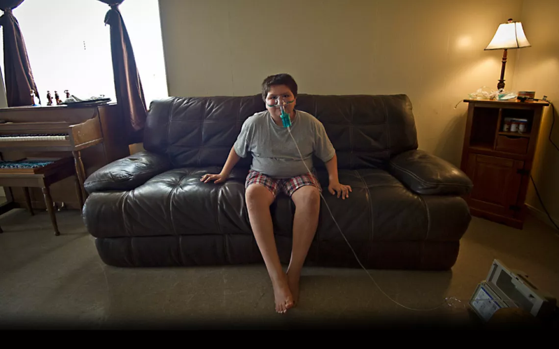 Lane Miller of Moapa, Nevada, demonstrates his nebulizer. "At least once a month he has to use a nebulizer to open up his lungs," his mother Kami said. "If I neglect it, he has to go on steroids or it can turn into pneumonia or bronchitis."