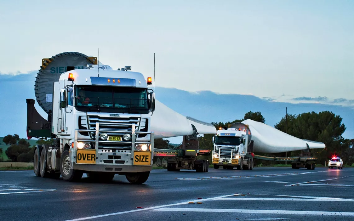 Workers watch turbine construction