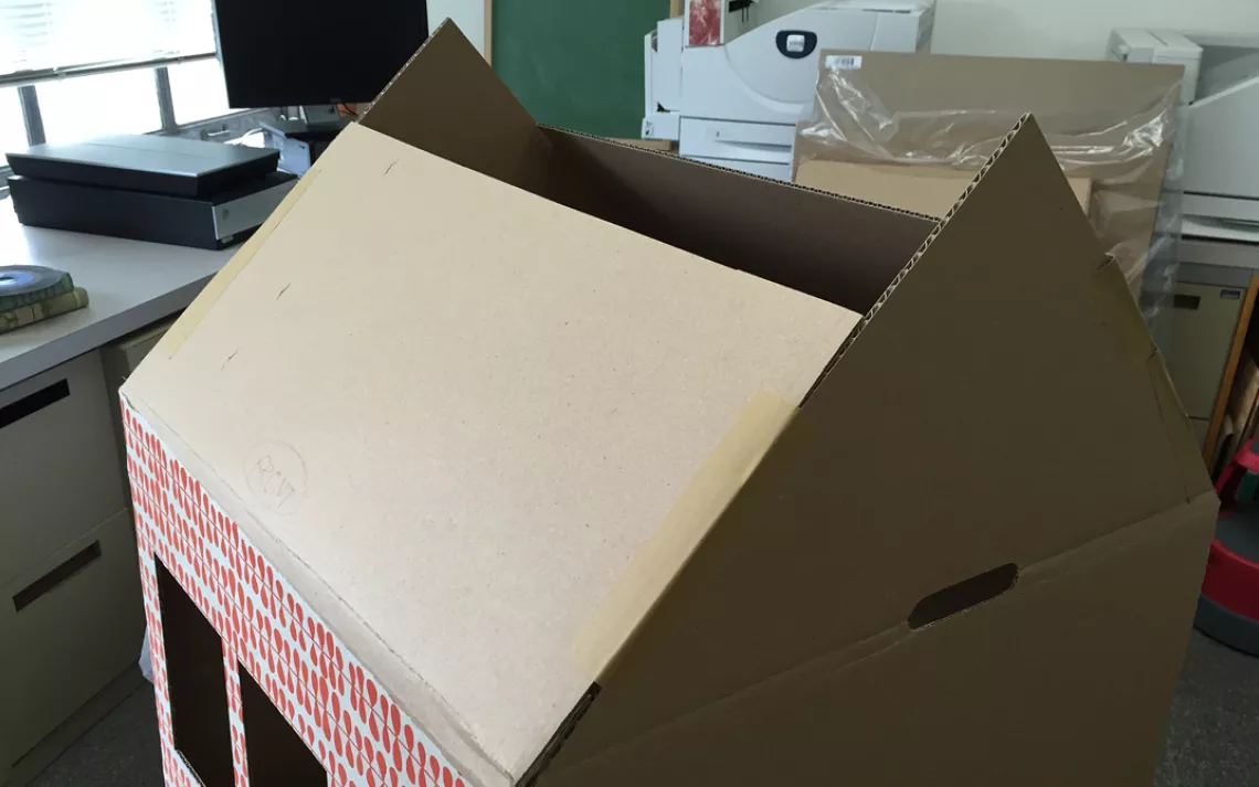 To construct the roof, make the pitch cuts on the top flaps of the box and tape together.