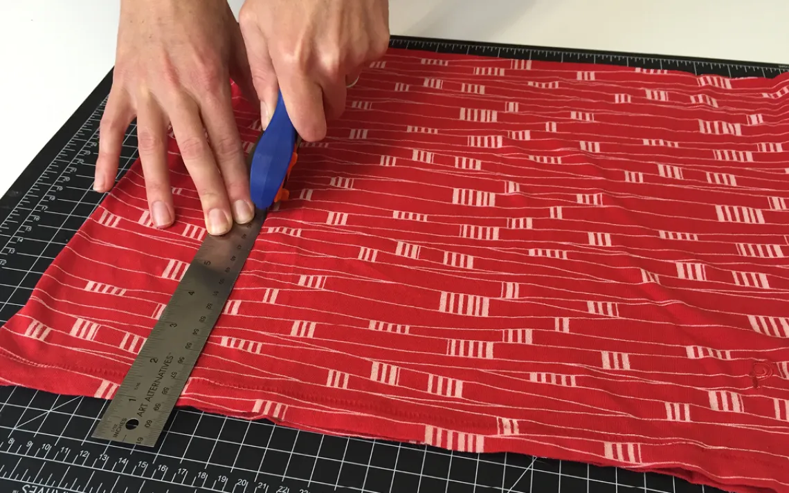 Decide the width you want for your bag and trim the sides accordingly. Or, skip this step and use the natural side seams of the t-shirt.