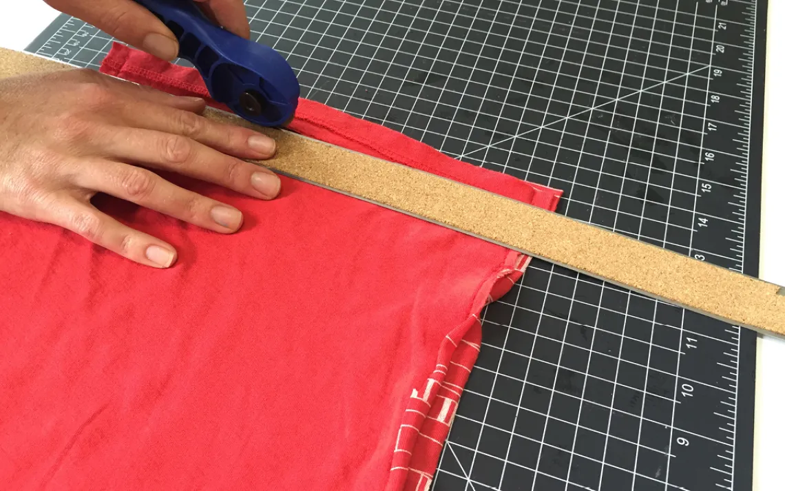 Decide where you would like to situate the handle (It should be at least one inch down from the top of the bag). Draw a line about three-inches long and cut.