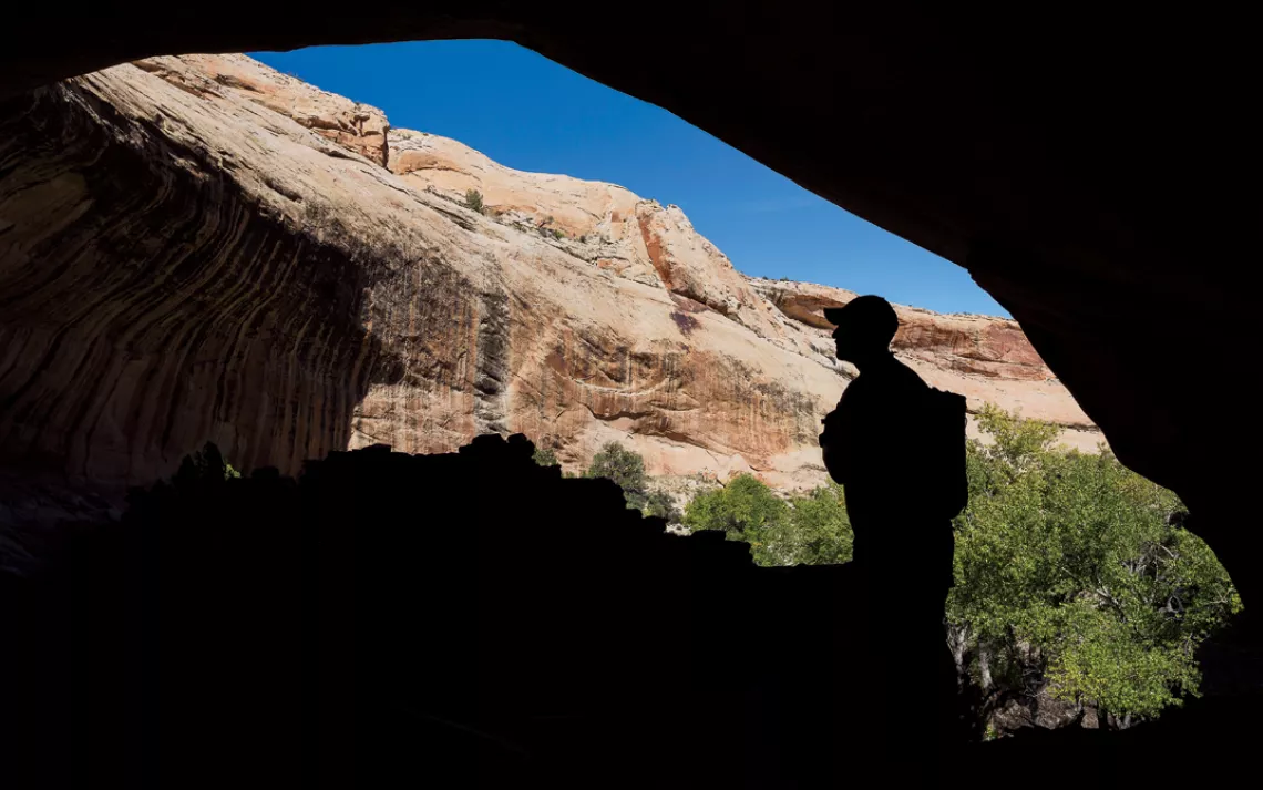 The silhouette of a man overlooks Cedar Mesa.