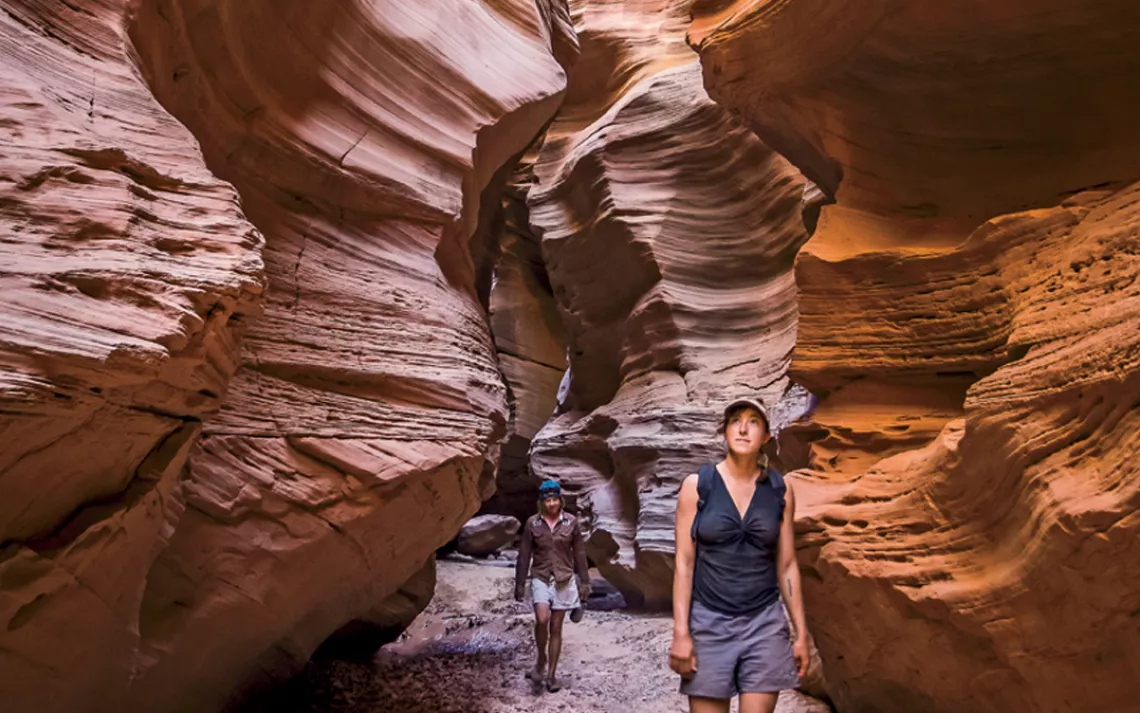 A woman hikes through the Fins in the Maze district of Canyonlands National Park, Utah.
