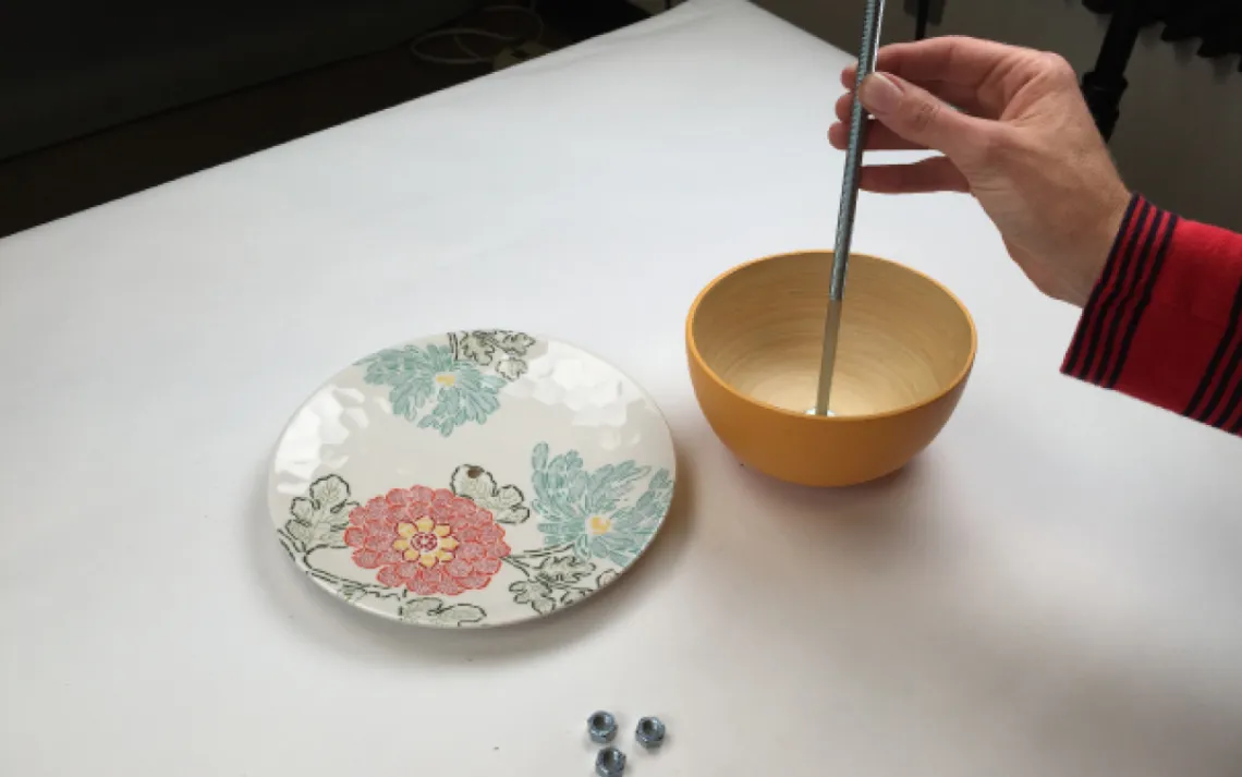  Slip a washer onto your carriage bolt, and slide it down to the bottom. Slide the bowl to the bottom to rest on the washer. Then apply a little glue to the washer to help stabilize the bowl.