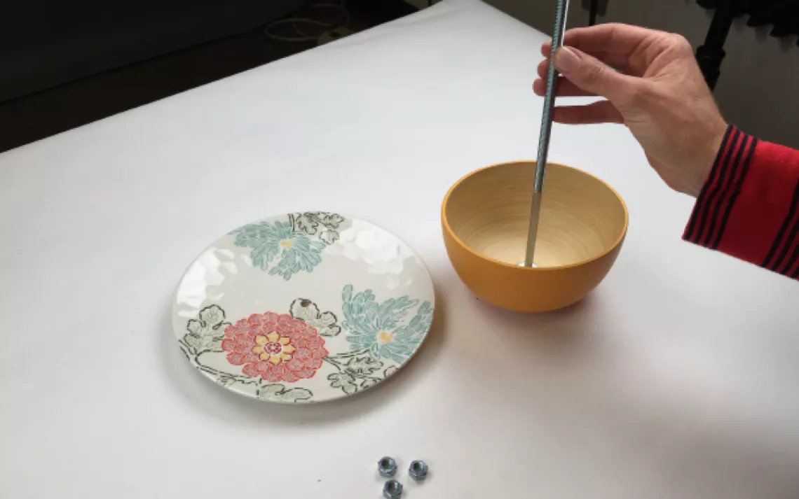  Slip a washer onto your carriage bolt, and slide it down to the bottom. Slide the bowl to the bottom to rest on the washer. Then apply a little glue to the washer to help stabilize the bowl.