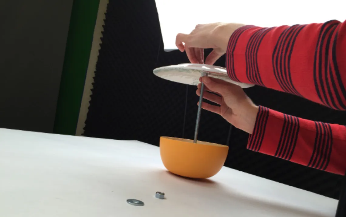 Take a nut and thread it a few inches down the carriage bolt. Put the plate (facing down) on top of this nut, and thread another nut onto the carriage bolt. Tighten the two bolts by hand so that the plate is secure.