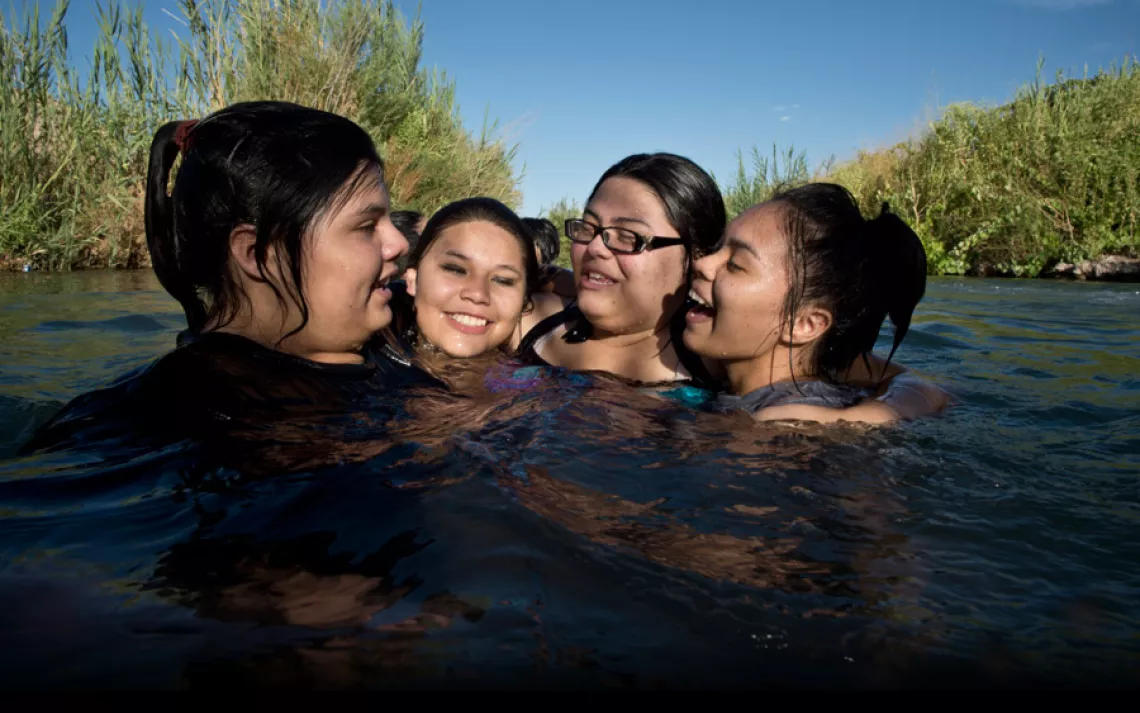 Ayona Hernandez, Summer Nickrand, and Zayda and Aaliyah Hernandez cool off in the Muddy River, about a mile from their Moapa home.