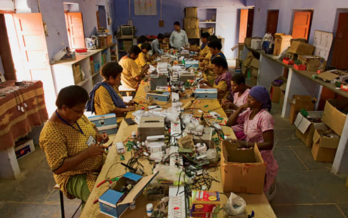 With help from their Hindi-speaking teachers, women from Fiji and Benin build solar lights.