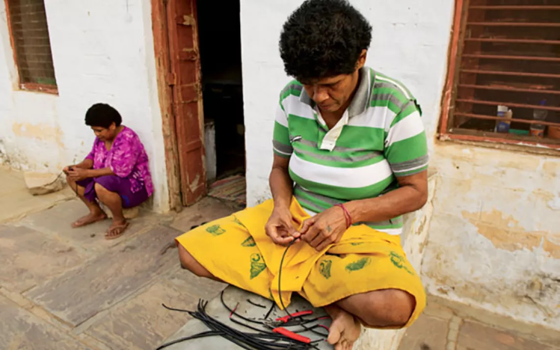 After dinner, Fijians Lusiana Rokovula and Reapi Vaitalea strip electrical wires to get ahead for the next day's class.