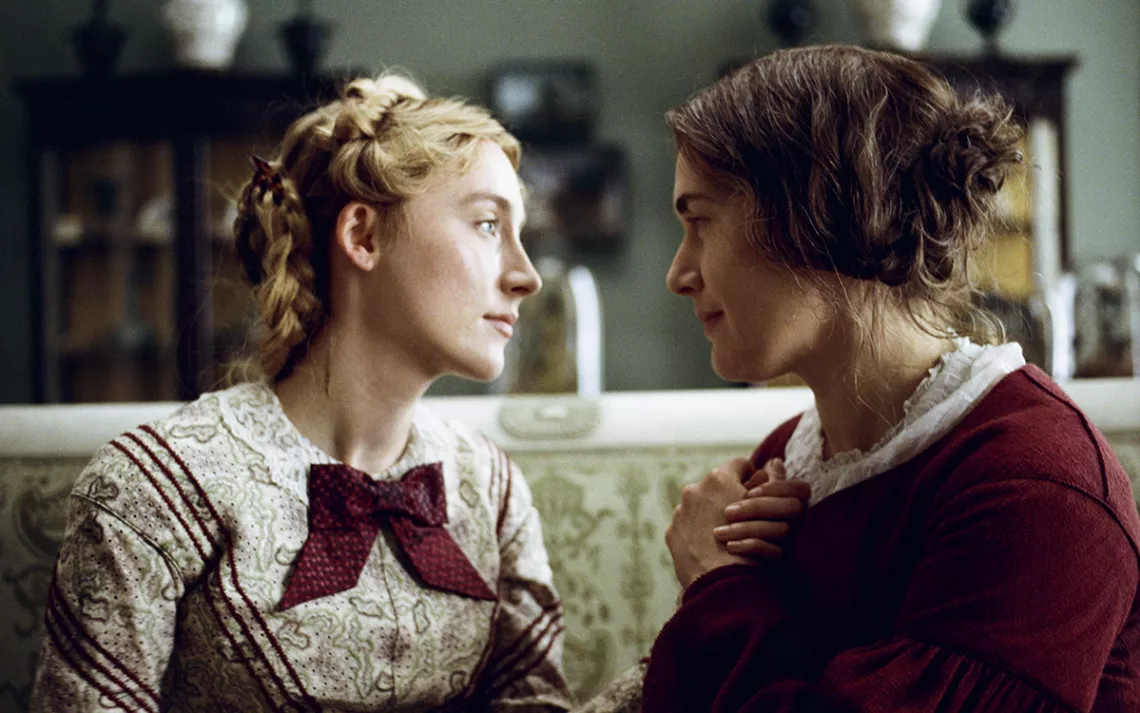 Saoirse Ronan and Kate Winset look deeply into one another's eyes in a well-lit room.