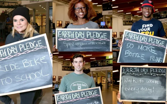 Students hold Earth Day Pledge signs that say "Ride Bike to School," "Spend more time with nature," "Do more bottle runs," and "Walk to work every day."