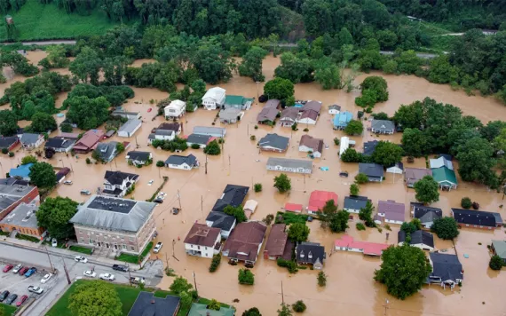 Aerial view shows the roofs of homes and buildings submerged in brown floodwaters in Jackson, Kentucky.