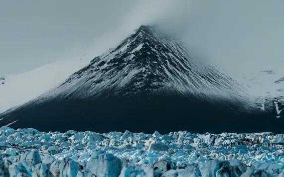 Close-up of Vatnajökull, with mist covering its top and chunky ice at its base.