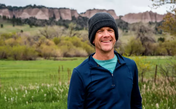 Steve Myers wears a knit cap and smiles at the camera.