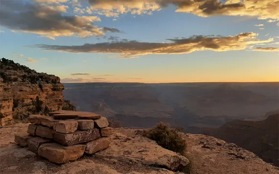 A deep canyon displaying towers and spires outlined by white sandstone.