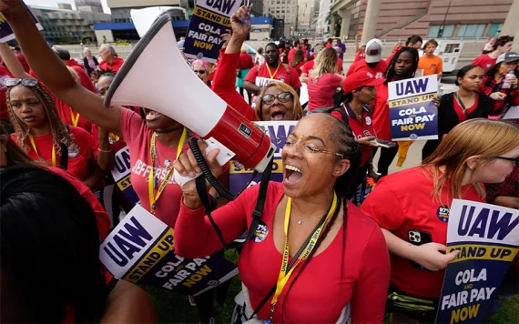 United Auto Workers member Tasha Johnson leads a chant while attending a rally in Detroit.