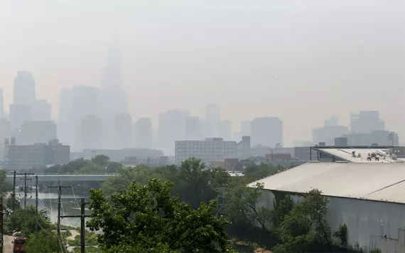 The downtown skyline and the iconic Willis Tower obscured by heavy smog.