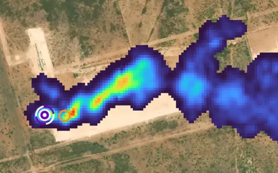 Satellite or aircraft aerial photo of a dark-blue-colored methane plume rising up from a source in a flat, dry area of Midland, Texas