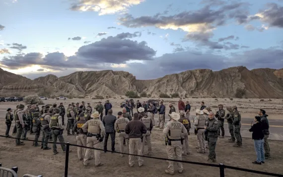 U.S. Rangers, and other law enforcement officers gather early morning ahead of a planned President Joe Biden's trip Tuesday, Jan. 7, 2025, to the Eastern Coachella Valley, Calif., where he was to announce the creation of the Chuckwalla National Monument before the trip had to be cancelled due to dangerously high winds. (AP Photo/Damian Dovarganes)