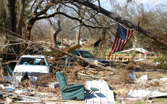 Cars, couches, and the wreckages of homes lay strewn amid fallen trees following Hurricane Katrina