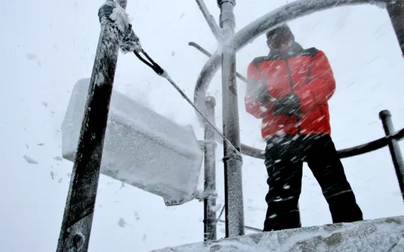 A weather observer knocked ice and snow off of a device atop Mount Washington