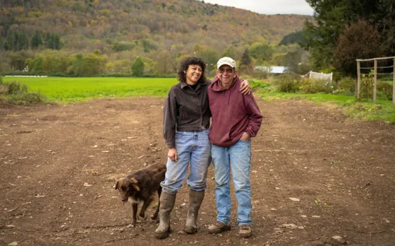 Tom Hutson (transitioning farmer) and Sea Matias (new generation farmer) stand together on the commons. Photo courtesy of Jamieson Johnson 