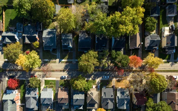 An aerial view of a lush community flushed with autumnal colors.