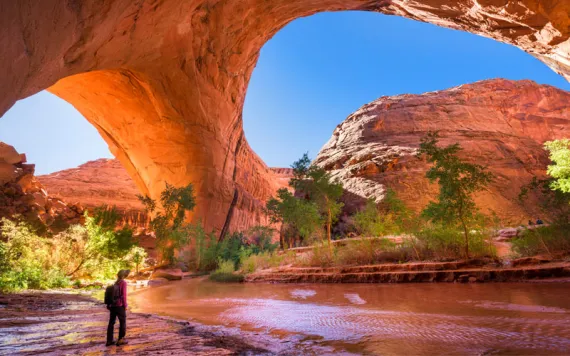 A hiker at Jacob Hamblin Arch in Coyote Gulch, Grand Staircase-Escalante National Monument, Utah, United States