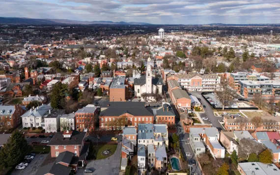 Wide aerial view of townscape with churches residential blocks and water tower in Frederick Maryland