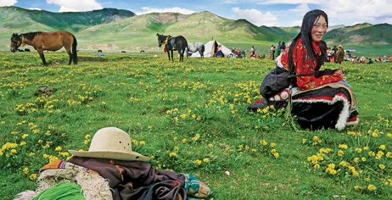 Near the headwaters of the Yellow River in China's Qinghai Province, a Golok nomad relishes the Tibetan Plateau's short-lived summer.