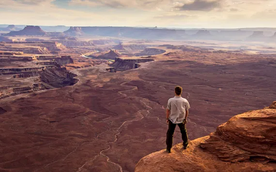 A man enjoys the view near Green River Overlook in Canyonlands National Park, Utah. 