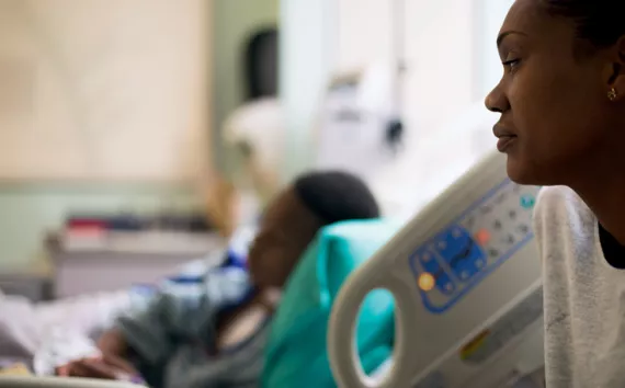 Raquel Williams, a resident of the Eight Mile neighborhood in Alabama gazes at her sick son, Markell. 