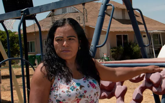 Fidelia Morales in her front yard. The orange groves around her house are frequently sprayed with pesticides. 